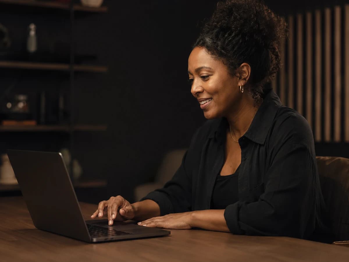 A creative small-business owner making AI-powered content on a laptop.